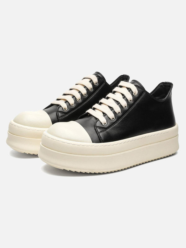TALISHKO black low-top sneakers with chunky soles and cream accents, perfect for urban style.