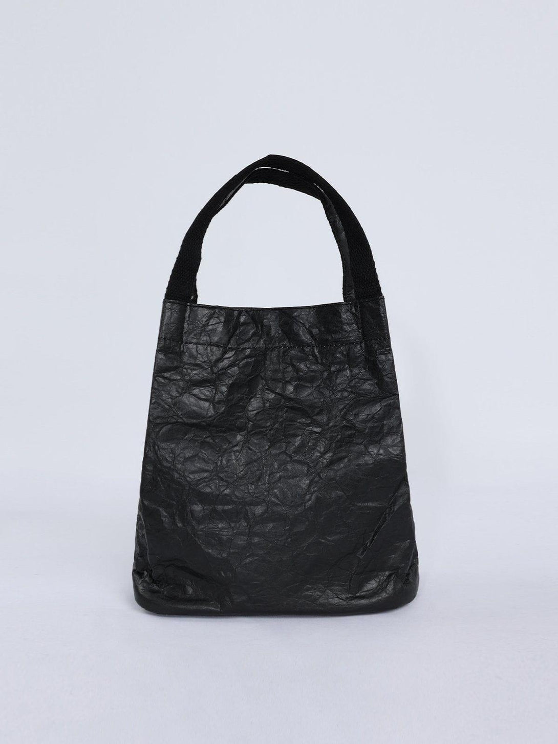 Front view of TALISHKO's black wrinkle kraft paper bag, highlighting its urban design.