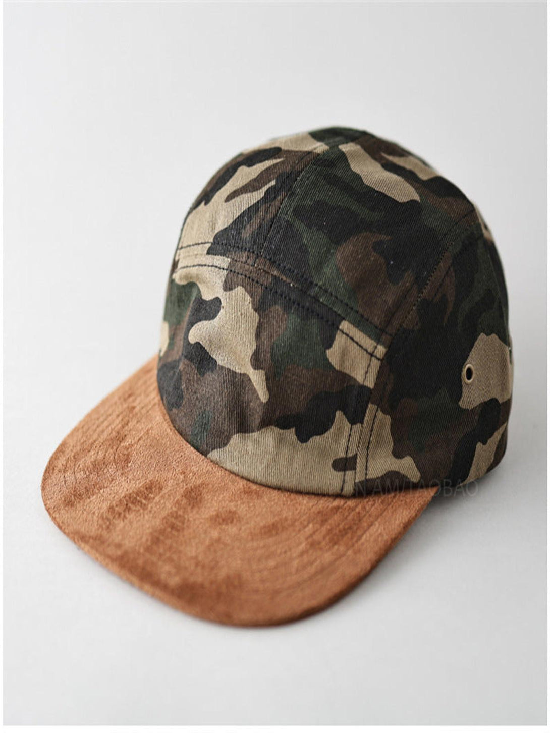 Front view of TALISHKO camouflage baseball cap with brown suede brim, adding a trendy edge.