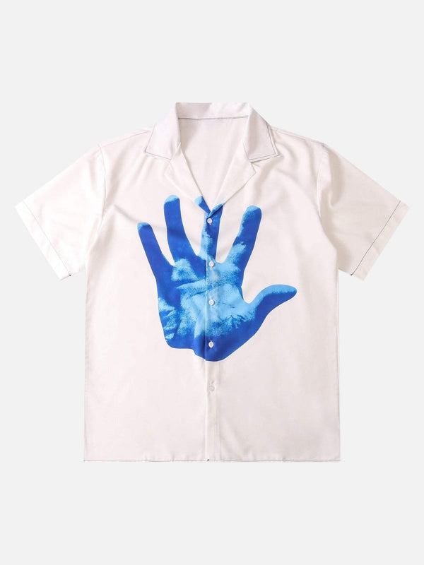 Front view of a white short sleeve shirt by TALISHKO featuring a bold blue palm print design.