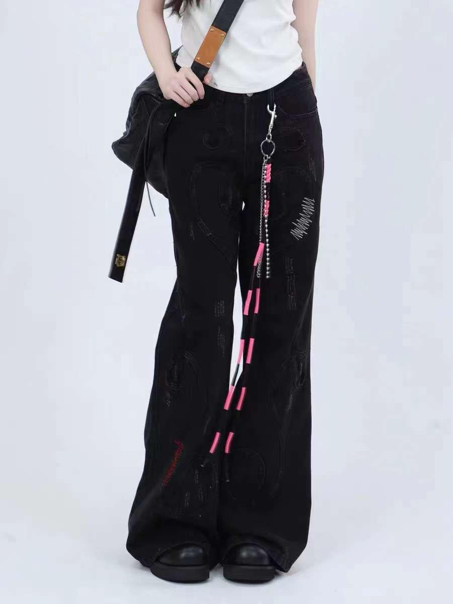 Model in TALISHKO black jeans with unique accents and wide-leg fit, paired with casual shoes.