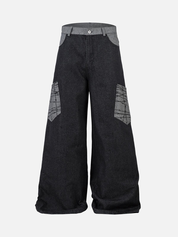 Front view of black baggy jeans by TALISHKO, featuring distinctive patch pockets and relaxed fit.
