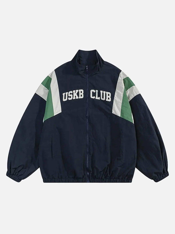 Front view of a blue windbreaker jacket with patchwork design by TALISHKO, perfect for trendy styles.
