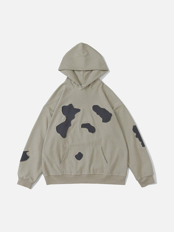 Gray patchwork hoodie by TALISHKO, featuring a unique design in a front view for urban style.