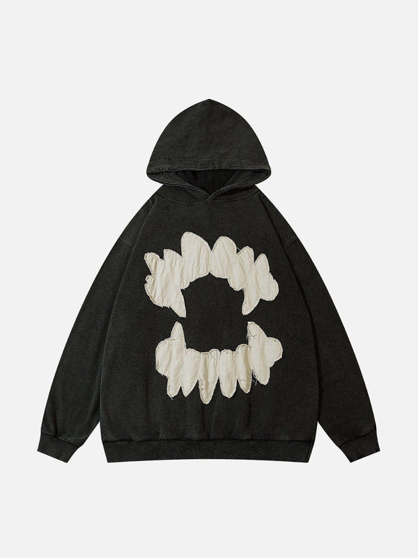 Front view of a black hoodie with tooth patchwork design, crafted by TALISHKO.