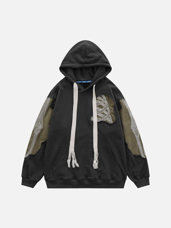 Front view of a dark gray patchwork skeleton hoodie by TALISHKO, featuring unique street style.