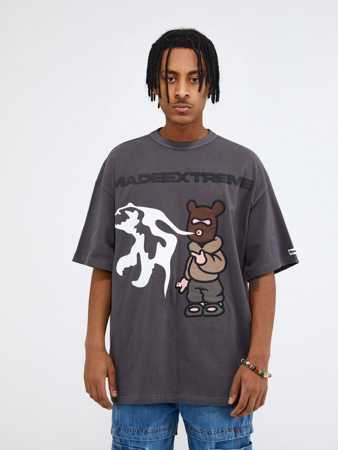 Front view of a gray TALISHKO graphic tee with playful bear and abstract design, ideal for casual wear.