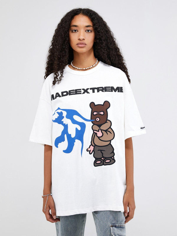 Model wearing a white TALISHKO graphic tee with playful bear design, perfect for casual style.