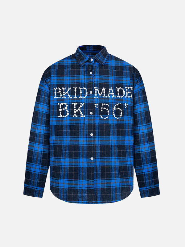 Plaid long sleeve shirt with bold lettering by TALISHKO, featuring a blue checkered pattern.