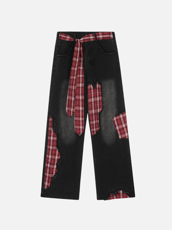 Front view of TALISHKO black jeans with red plaid patchwork, offering a bold street style.