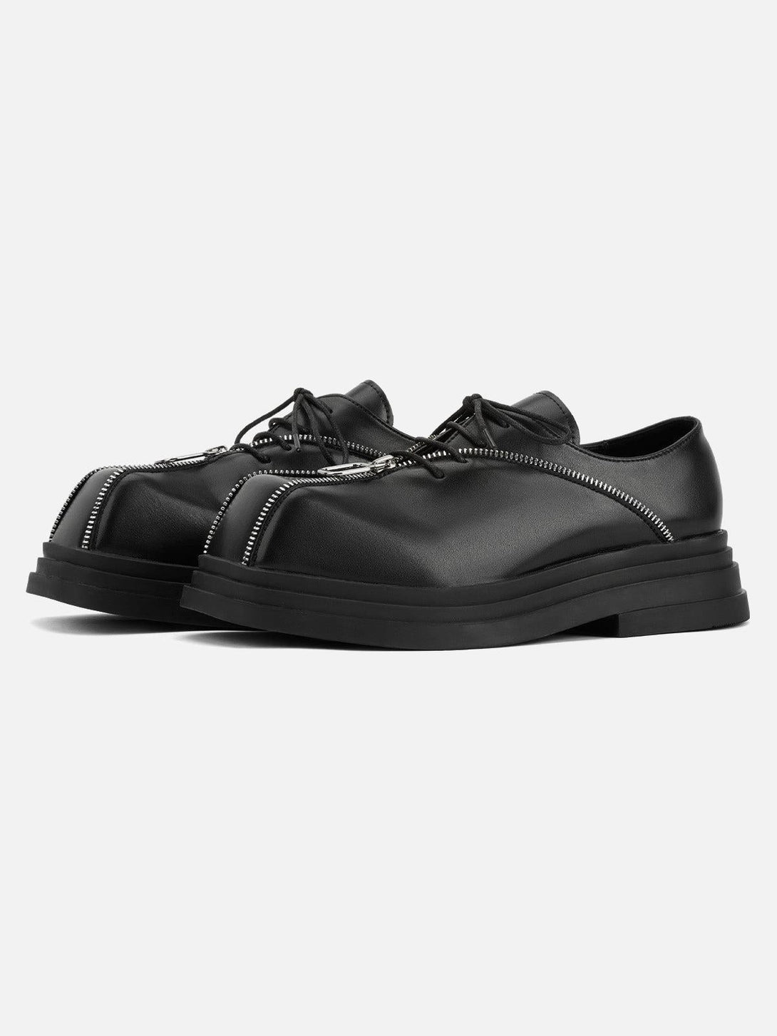 Front view of black leather shoes featuring a unique zipper design by TALISHKO, perfect for edgy style.