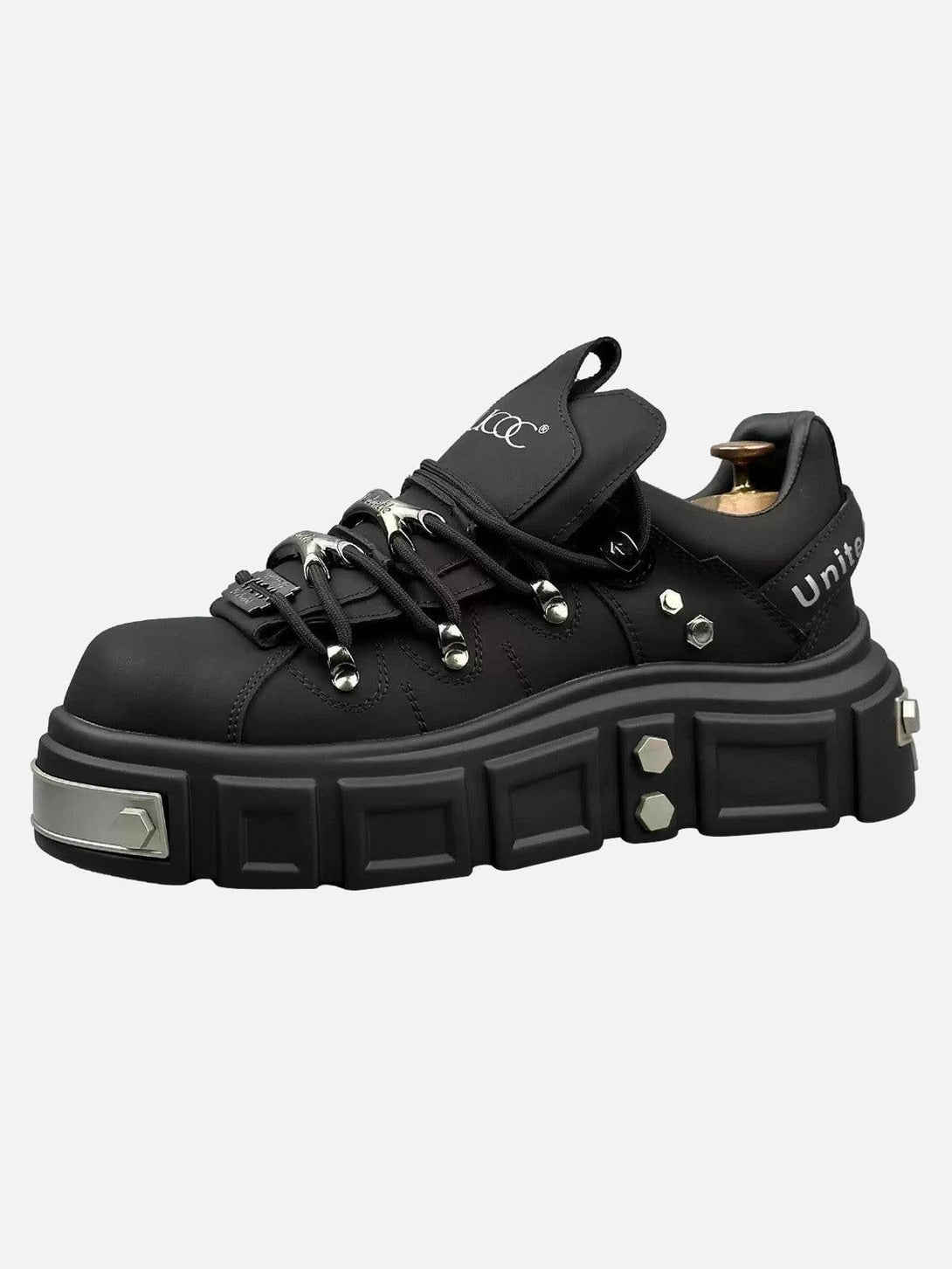 Edgy black derby shoes by TALISHKO, featuring chunky soles and rivet accents in a punk style.