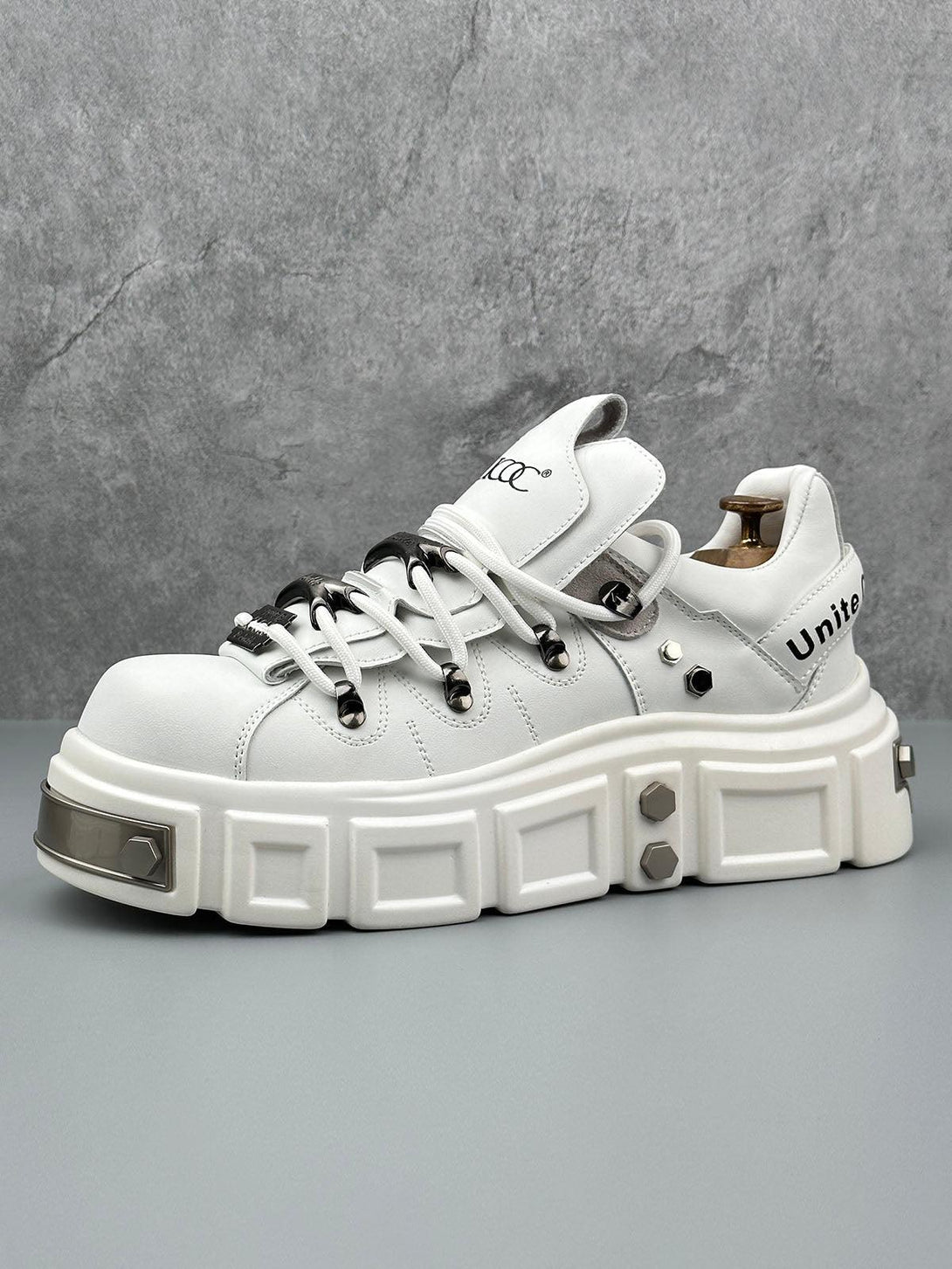 White derby shoes with chunky soles and rivet accents by TALISHKO, ideal for edgy style.