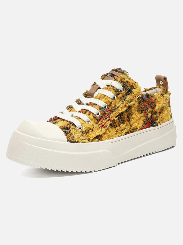 Retro canvas sneakers by TALISHKO in orange, featuring a textured front view design.
