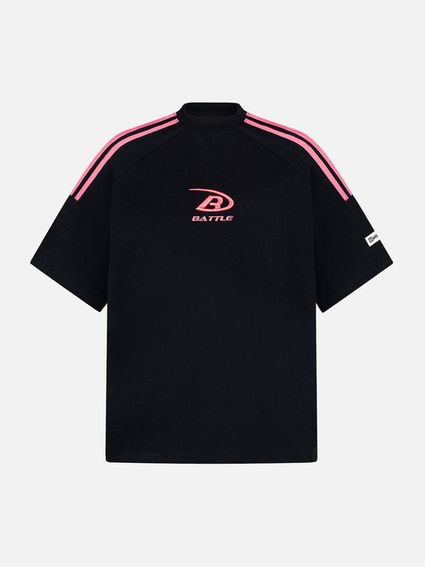 Front view of a black retro patchwork stripe short sleeve t-shirt by TALISHKO with pink accents.