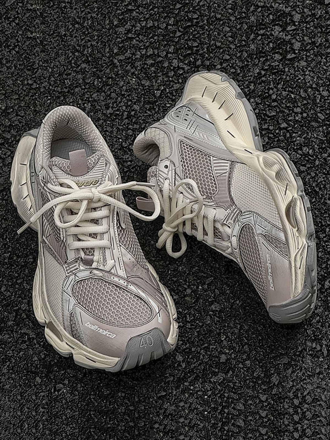 TALISHKO beige sneakers featuring a chunky retro design on asphalt for a trendy urban look.