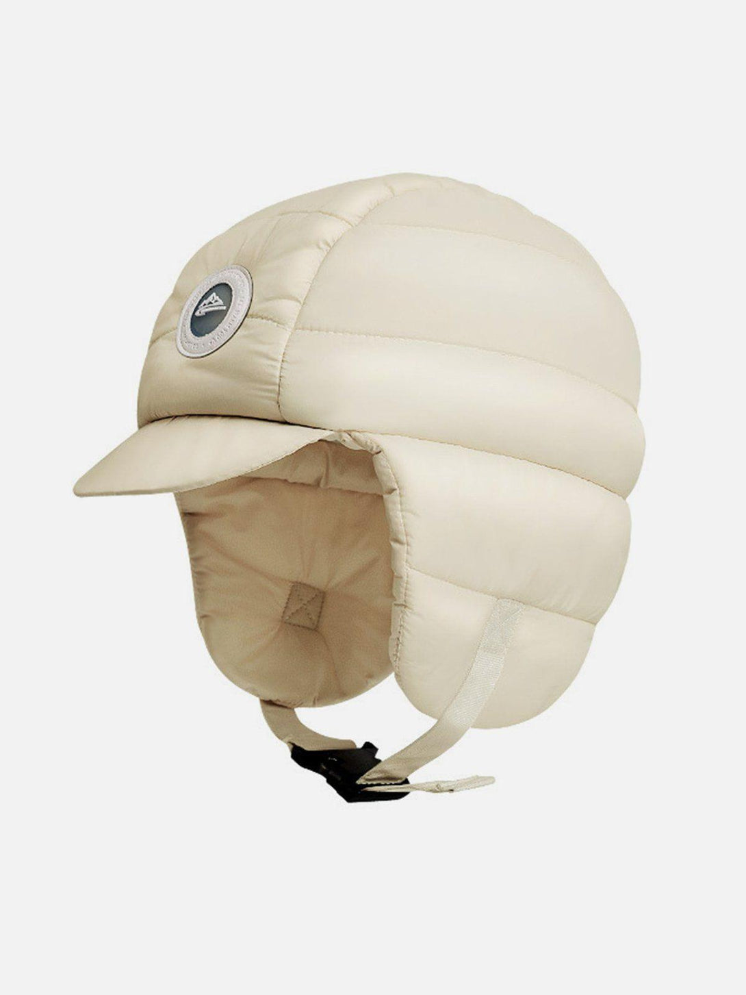 Front view of a beige ear protection hat by TALISHKO, featuring a quilted design and chin strap.