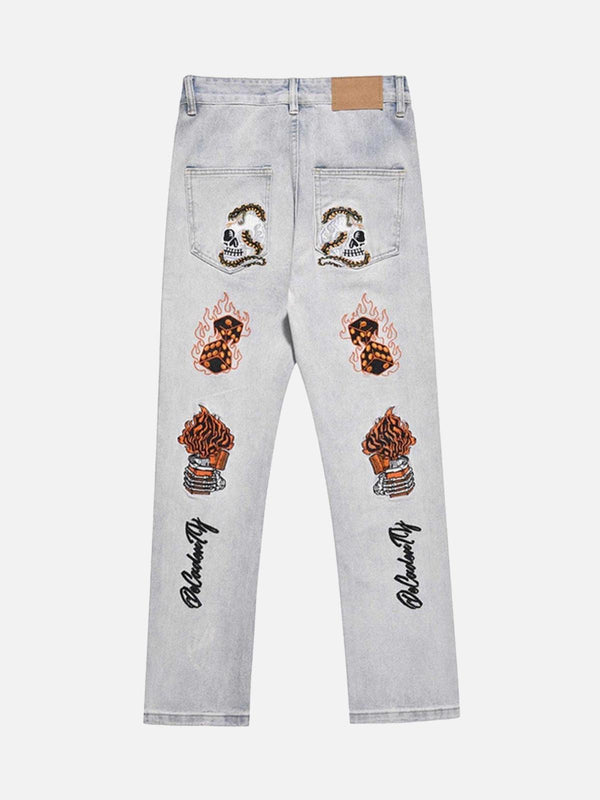 Back view of TALISHKO slim fit jeans in blue, featuring skull and flame embroidery.
