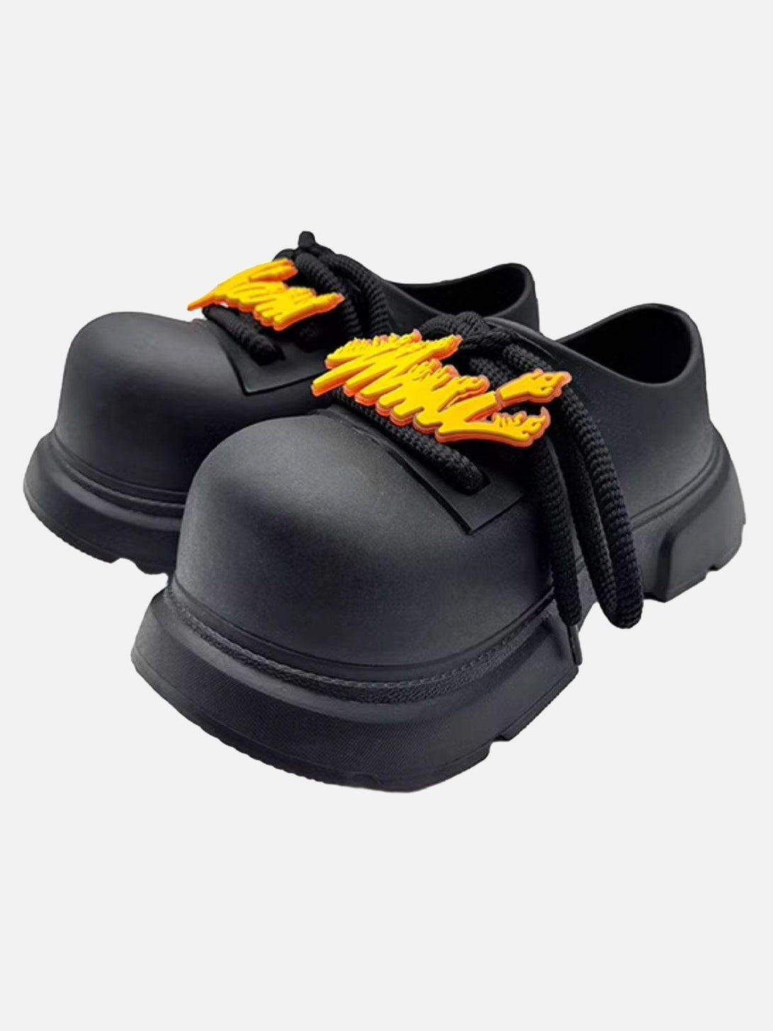 Front view of TALISHKO black slip-on derby platform shoes with bold orange accents.