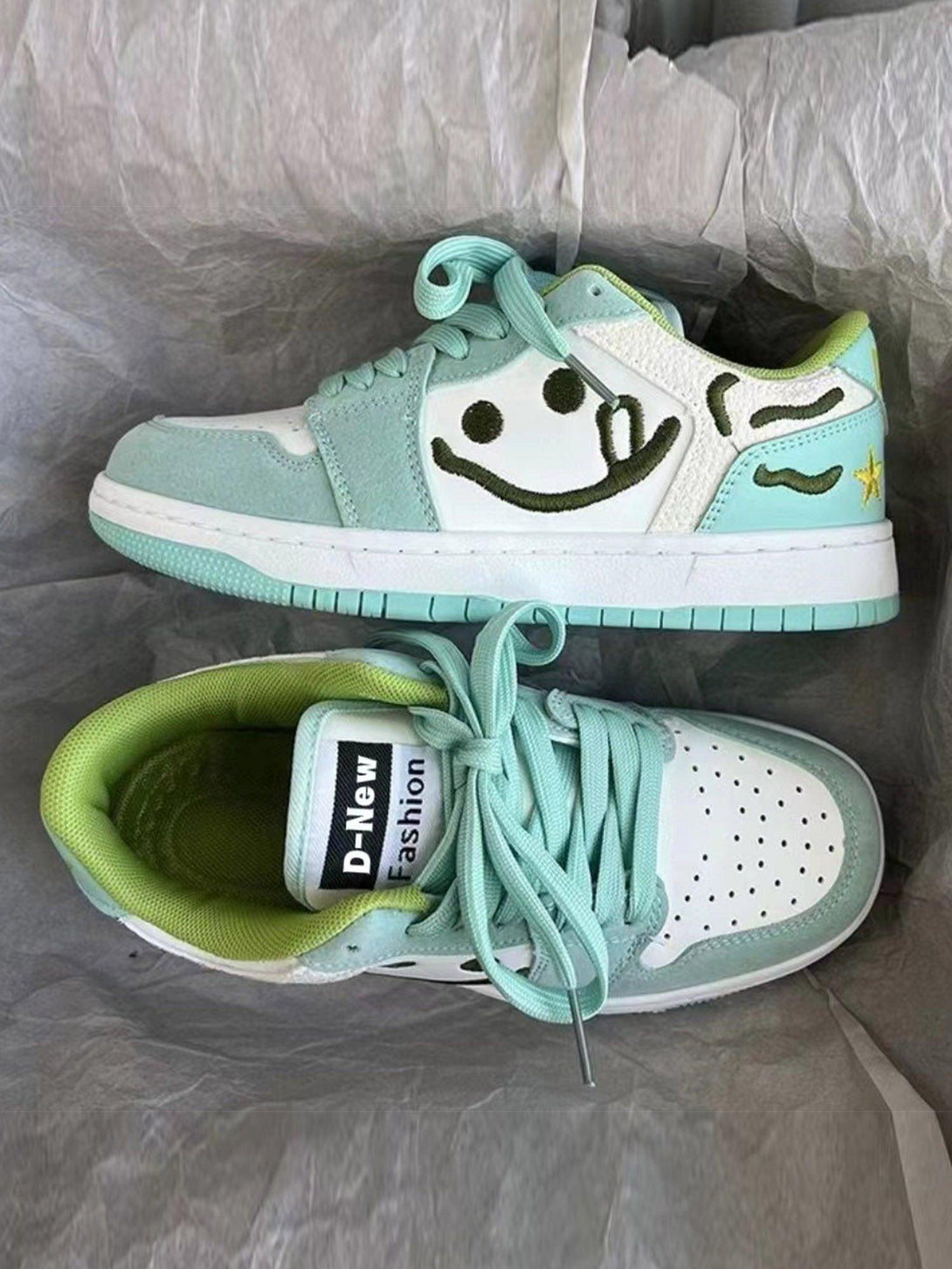 Front view of TALISHKO smiley skateboarding shoes in mint green, featuring playful design.