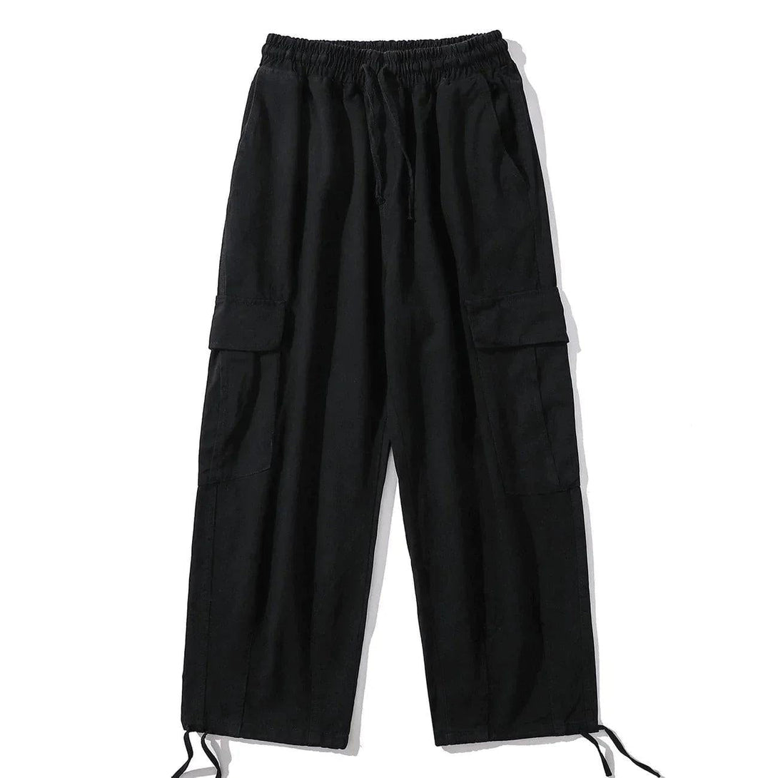 Front view of black cargo pants with drawstring waist and large pockets by TALISHKO.