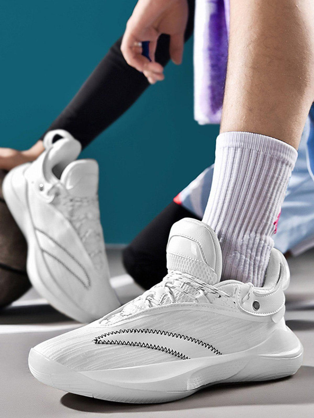 TALISHKO white breathable sneakers showcased in a sporty setting, highlighting sleek design.
