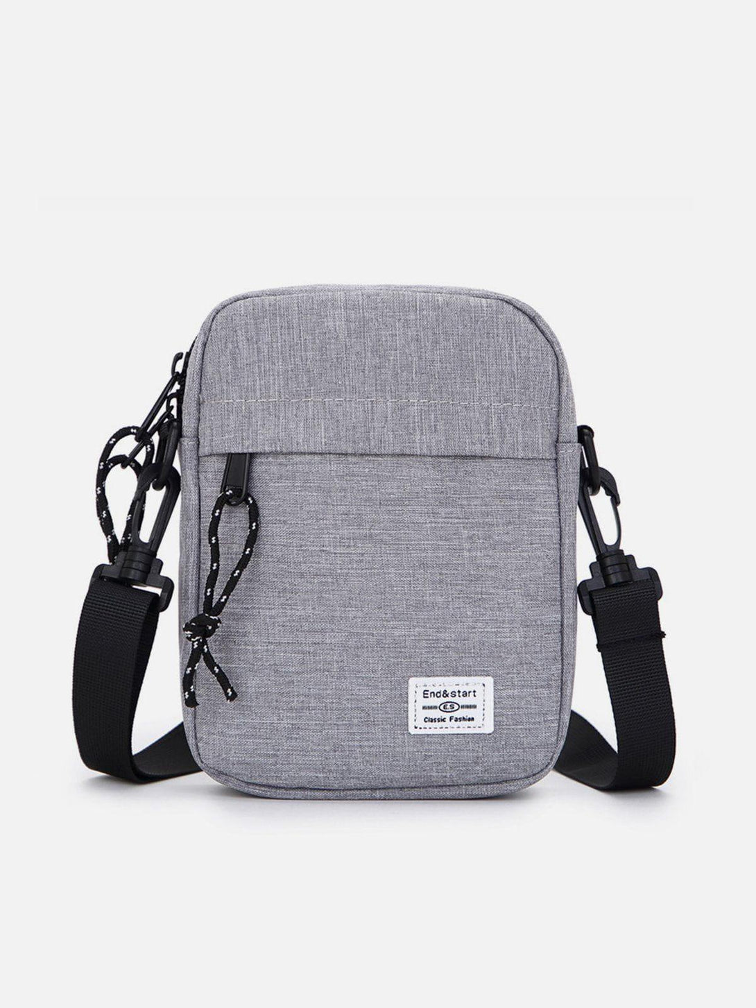 Front view of a light gray square crossbody bag by TALISHKO, featuring stylish rope accents.