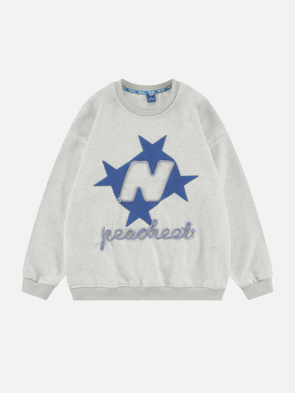 Gray sweatshirt with blue star and letter design, front view. Trendy piece by TALISHKO.