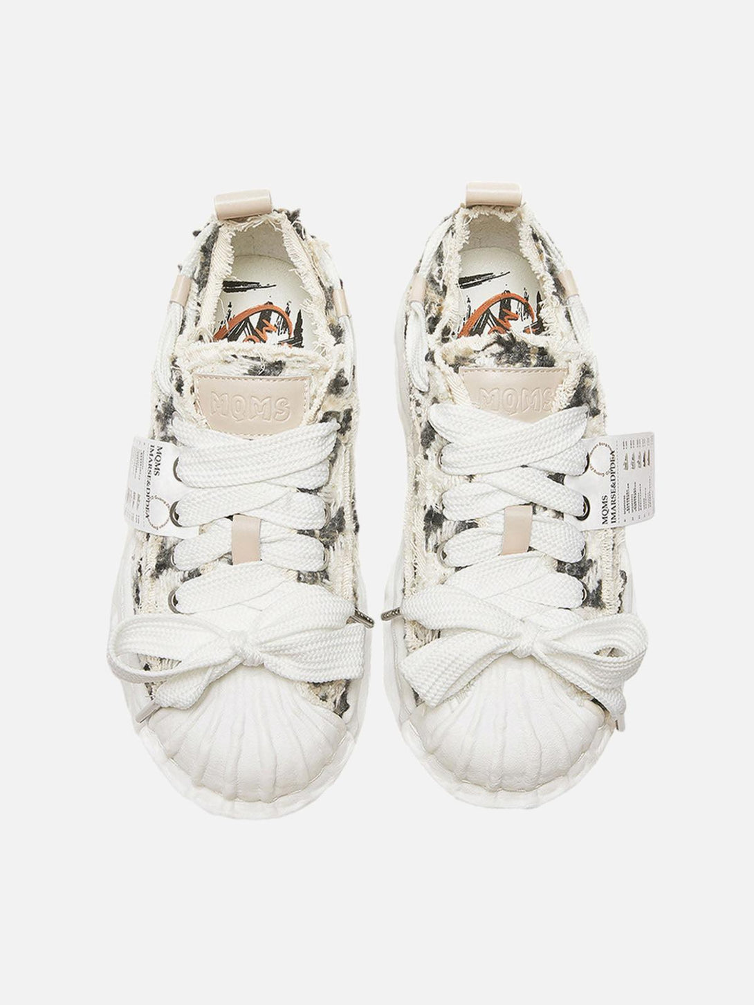 Front view of TALISHKO sneakers featuring a deconstructed design with textured brown accents.
