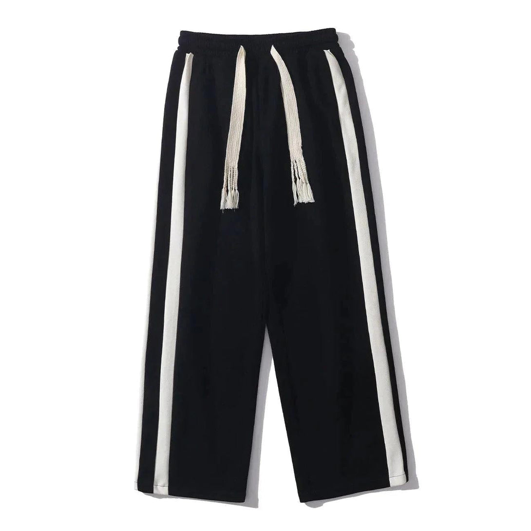 Front view of black striped patchwork pants by TALISHKO with a casual drawstring design.