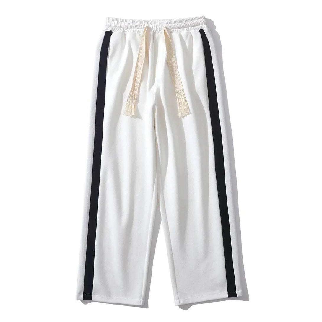 Front view of white striped patchwork pants by TALISHKO, featuring a relaxed drawstring fit.