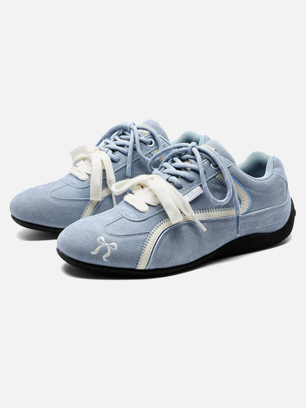 A front view of blue suede lace-up sneakers by TALISHKO, perfect for casual street style.