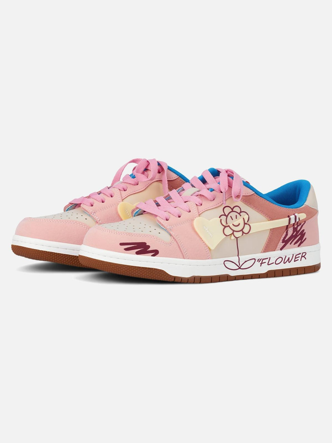 TALISHKO pink skate shoes with flower graphics and blue accents, front view.