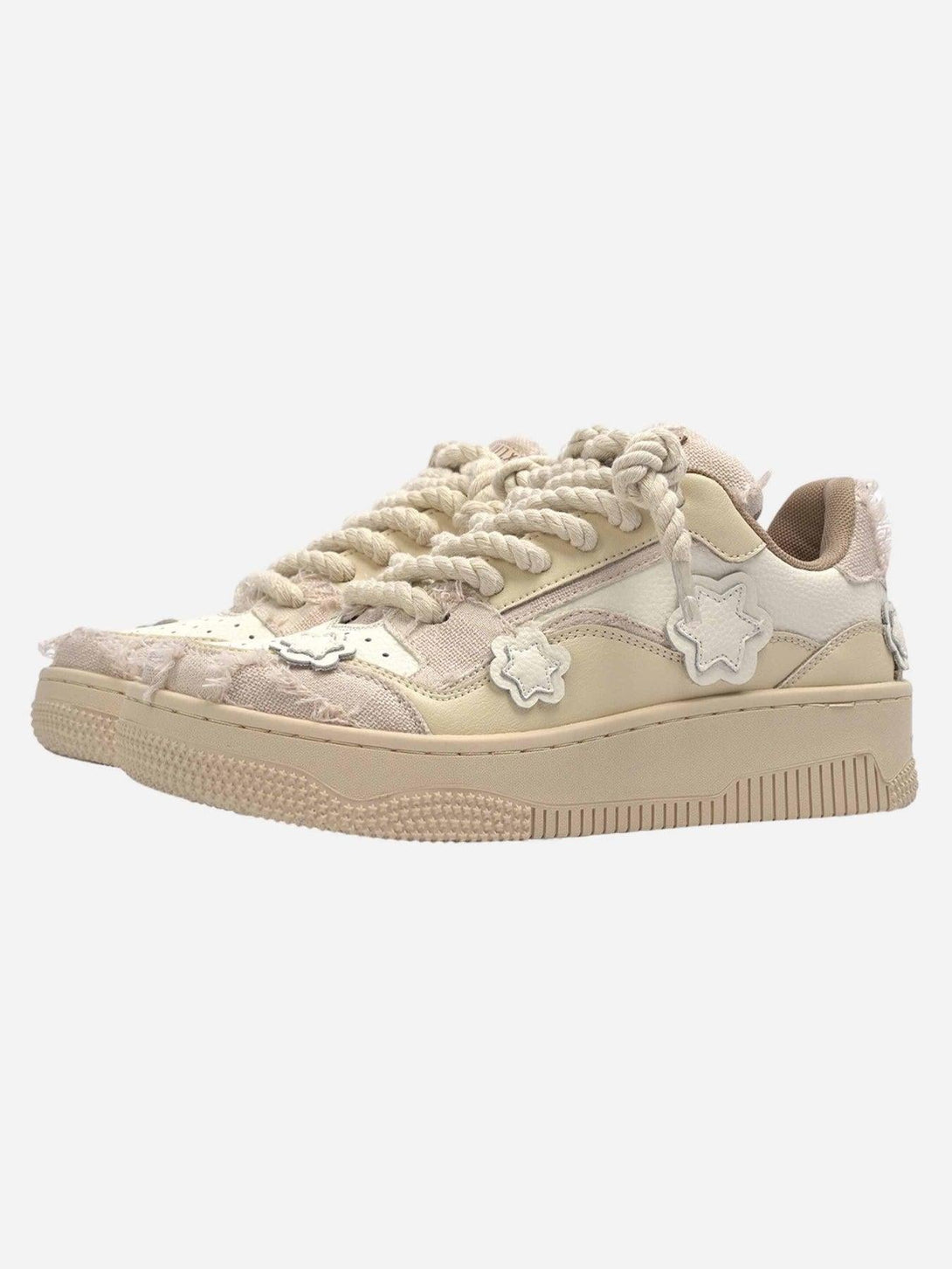 Beige low-top board shoes by TALISHKO with unique star details and chunky twine laces.