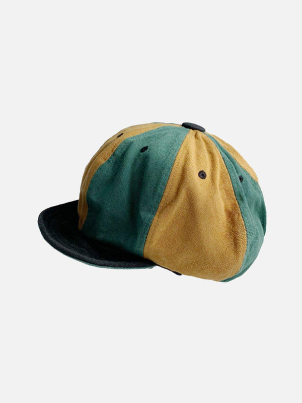 A vintage color block casual hat by TALISHKO, showcasing green and yellow panels.