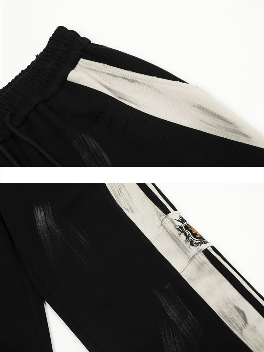 Close-up of TALISHKO vintage black sweatpants featuring bold brushstroke details and intricate design.