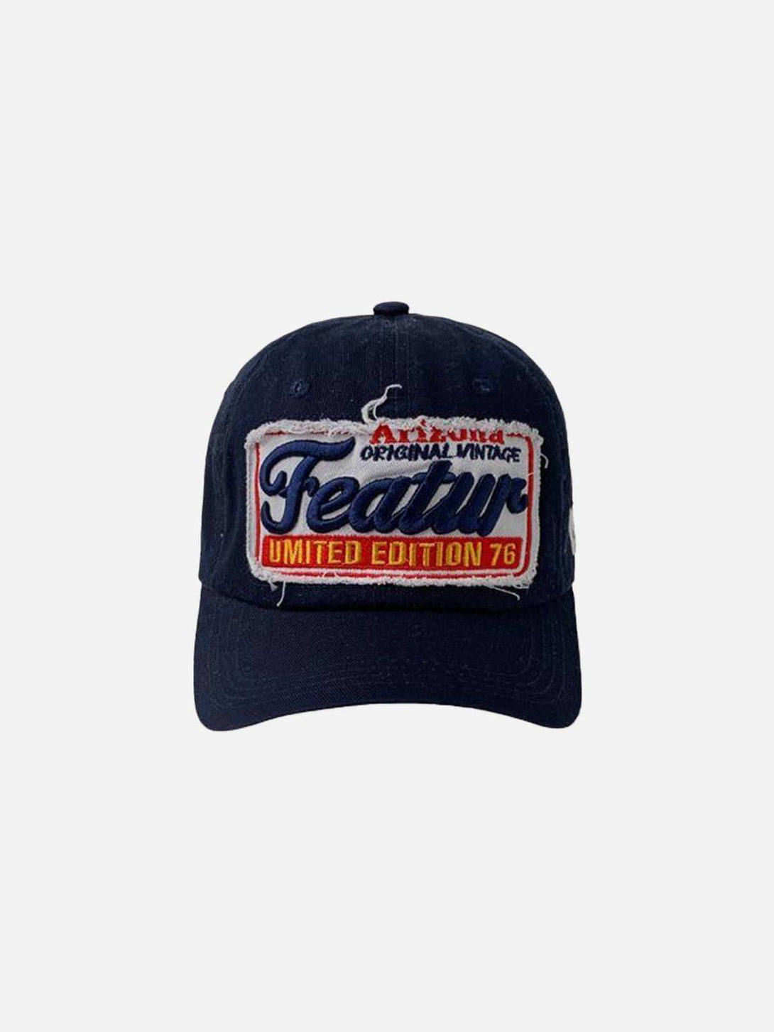 Front view of a navy blue vintage embroidery cap by TALISHKO, featuring a bold patch design.