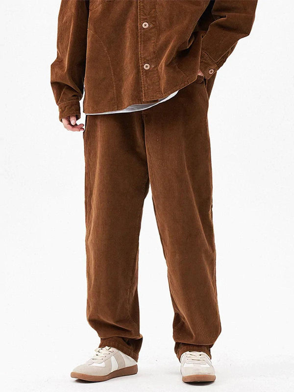 Model wearing brown corduroy pants by TALISHKO, highlighting a relaxed streetwear style.