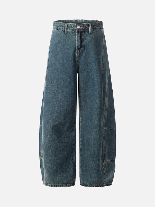 Front view of dark blue baggy barrel jeans by TALISHKO, showcasing a deconstructed style.