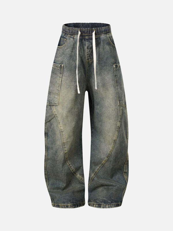 Front view of dark blue washed distressed barrel jeans with drawstring by TALISHKO, perfect for urban style.