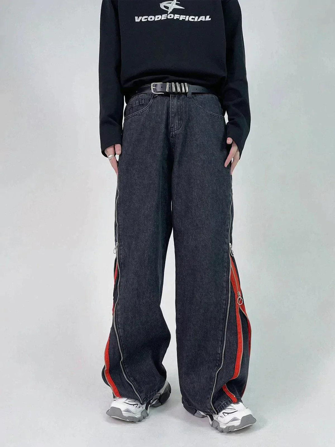Front view of TALISHKO black jeans featuring red stripe accents and a casual, relaxed fit.