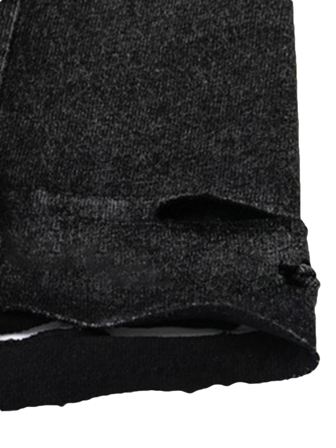 Detailed fabric and stitching on TALISHKO's distressed vest, emphasizing its unique texture.