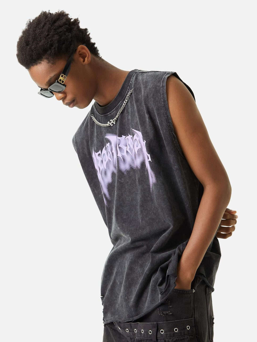 Model in TALISHKO washed vest with metallic purple print and chain detail, embracing edgy style.