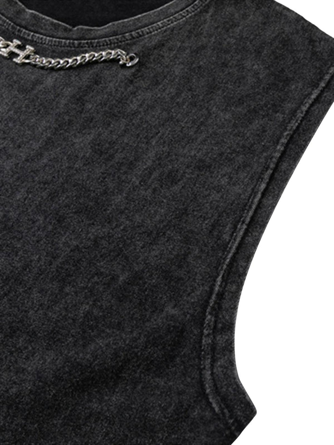 Detailed view of TALISHKO's distressed vest, highlighting the chain accent on washed fabric.