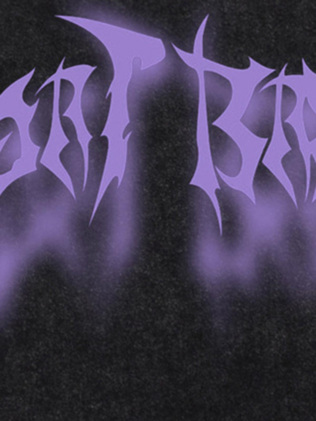 Intricate look at TALISHKO's distressed vest with bold purple lettering on a black fabric.