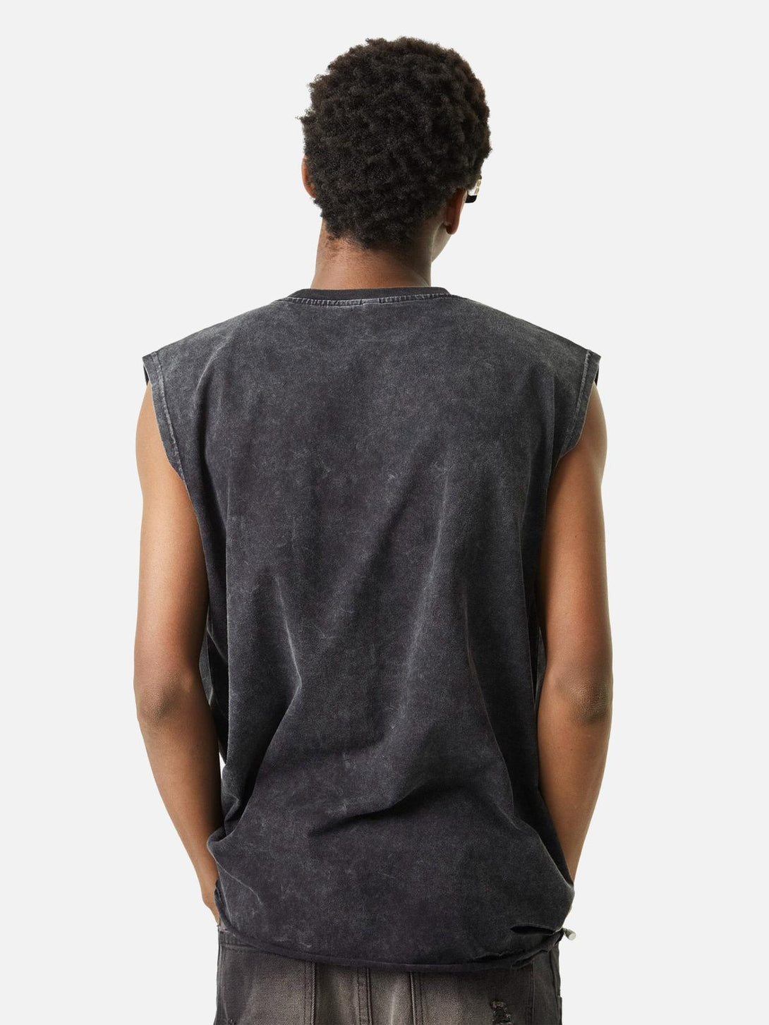 Back view of TALISHKO's washed vest showcasing its distressed fabric and relaxed fit.