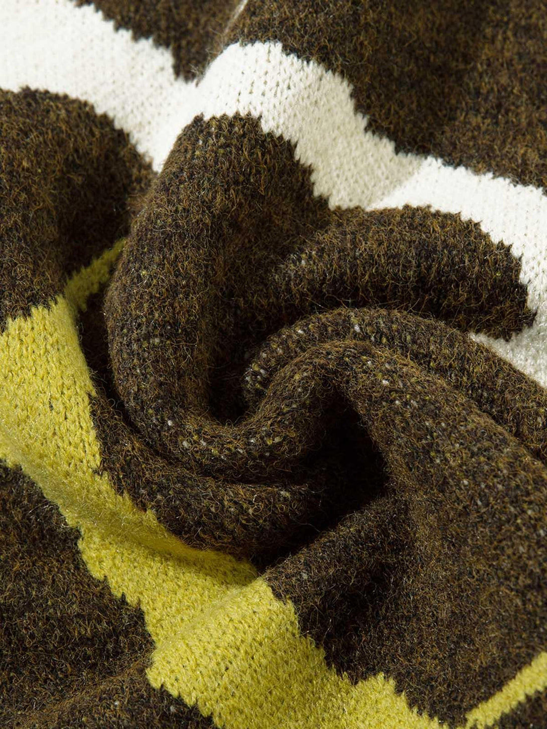Texture and pattern showcased on TALISHKO's thorn-patterned sweater, highlighting knit details.
