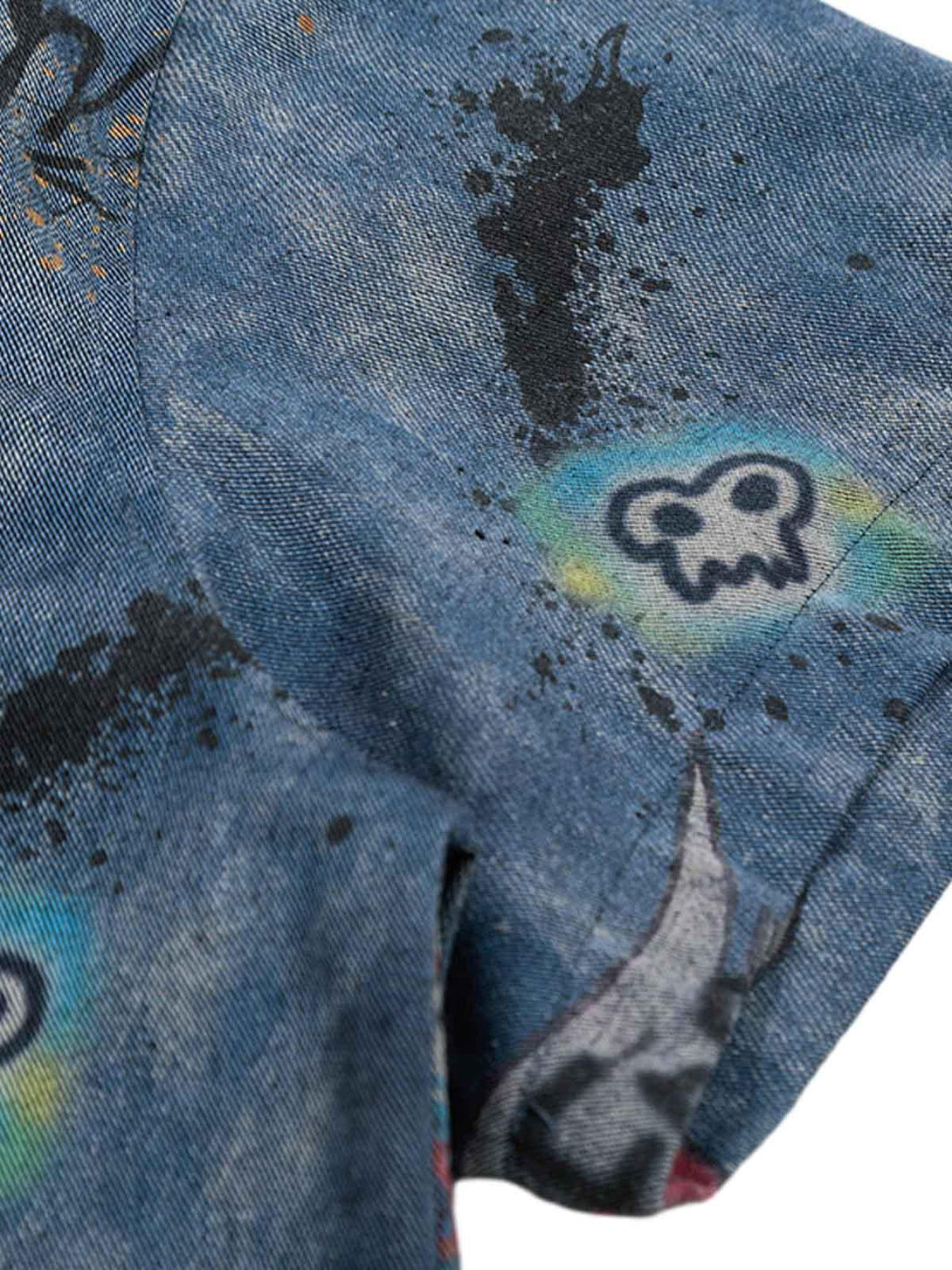 Zoomed-in texture of a tie-dye denim graffiti polo by TALISHKO, highlighting unique patterns.