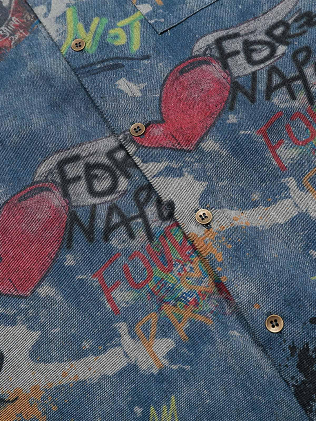 A close-up of the tie-dye denim graffiti polo by TALISHKO, highlighting its vibrant design.