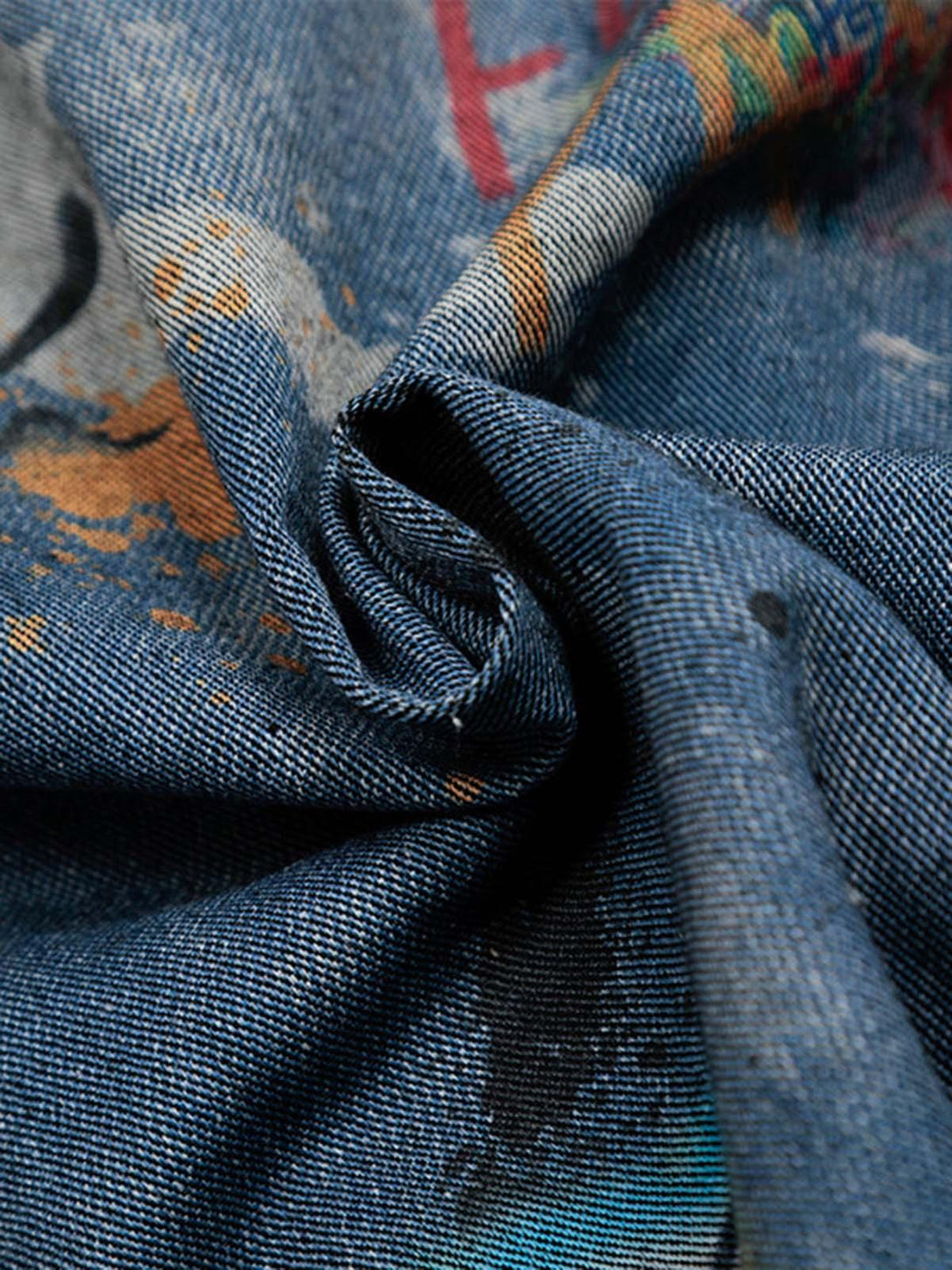 Intricate look at the tie-dye denim graffiti polo fabric by TALISHKO, showcasing vivid textures.